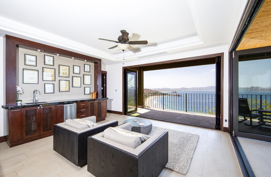 living room with wet bar and ocean views