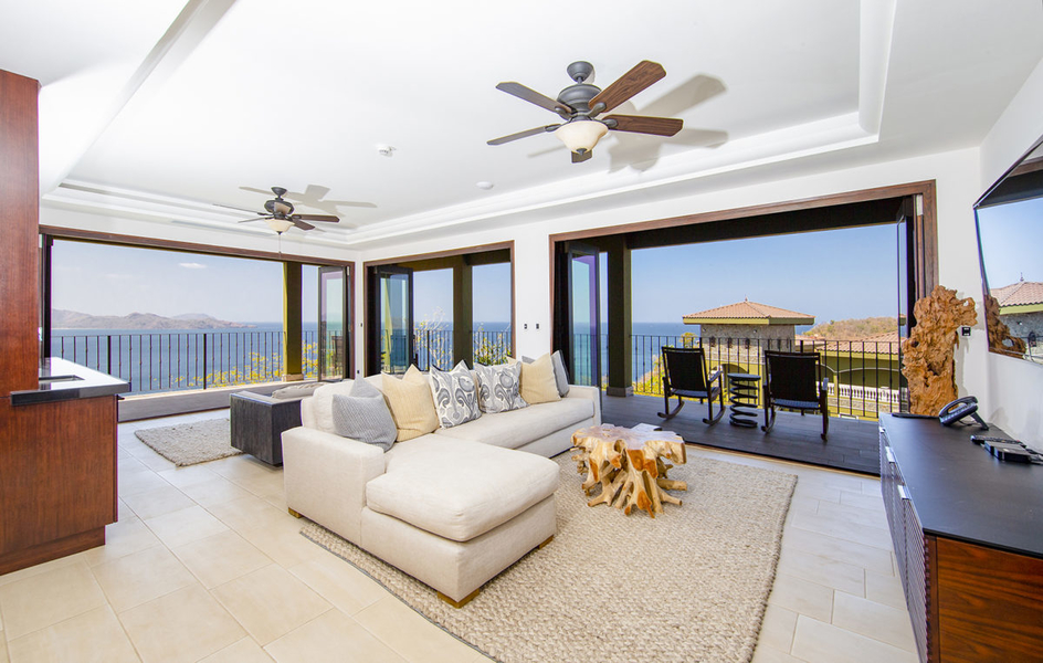 living room with bi-fold Pella doors and wraparound balcony