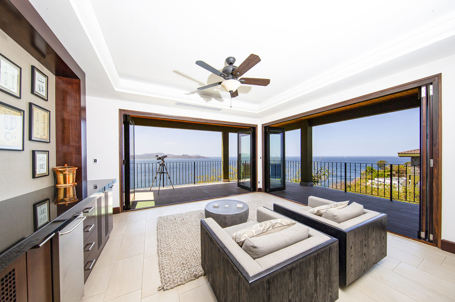 living room with bi-fold Pella doors and ocean views