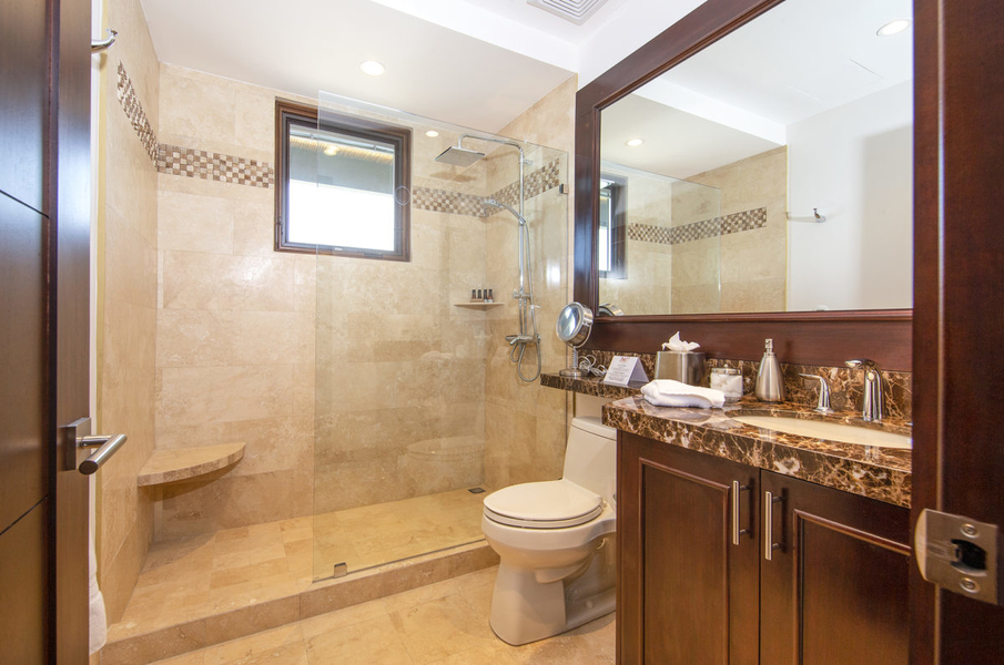 bathroom with double vanities and granite countertops